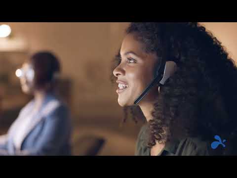 Carrera Software | A customer service representative with a headset smiling during a remote work conversation.